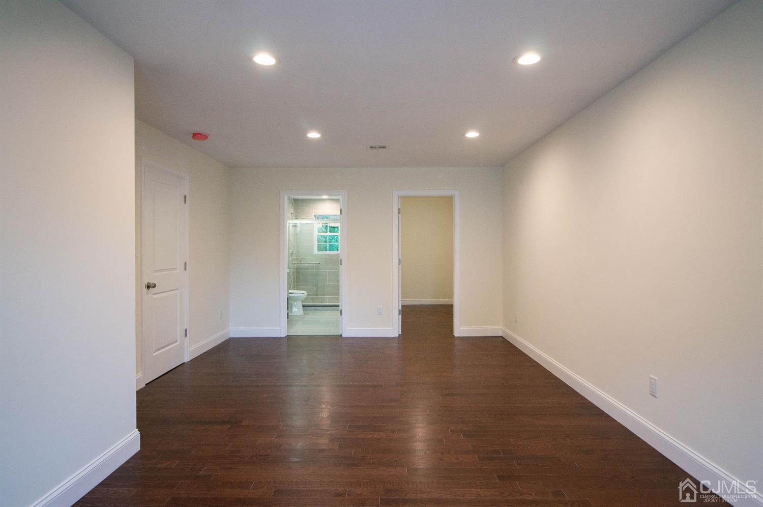14 Caldwell Road Edison, NJ 08817 - Photo 12 of 22 an empty room with wooden floor and windows