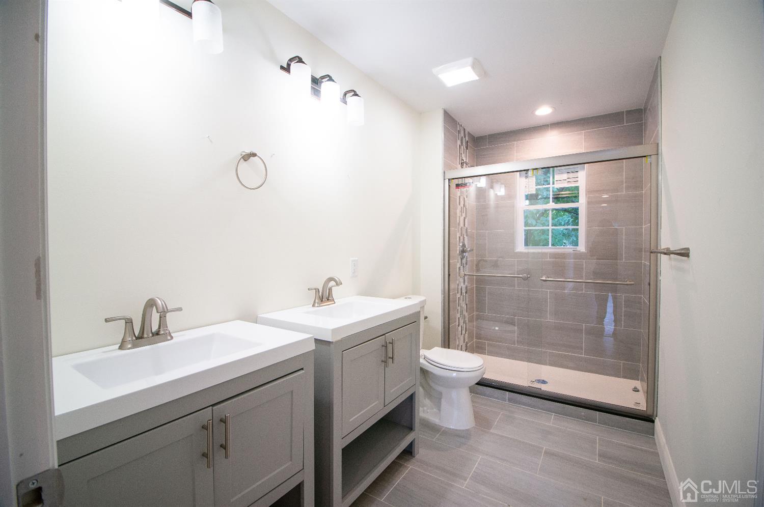 14 Caldwell Road Edison, NJ 08817 - Photo 13 of 22 a bathroom with a double vanity sink toilet and shower