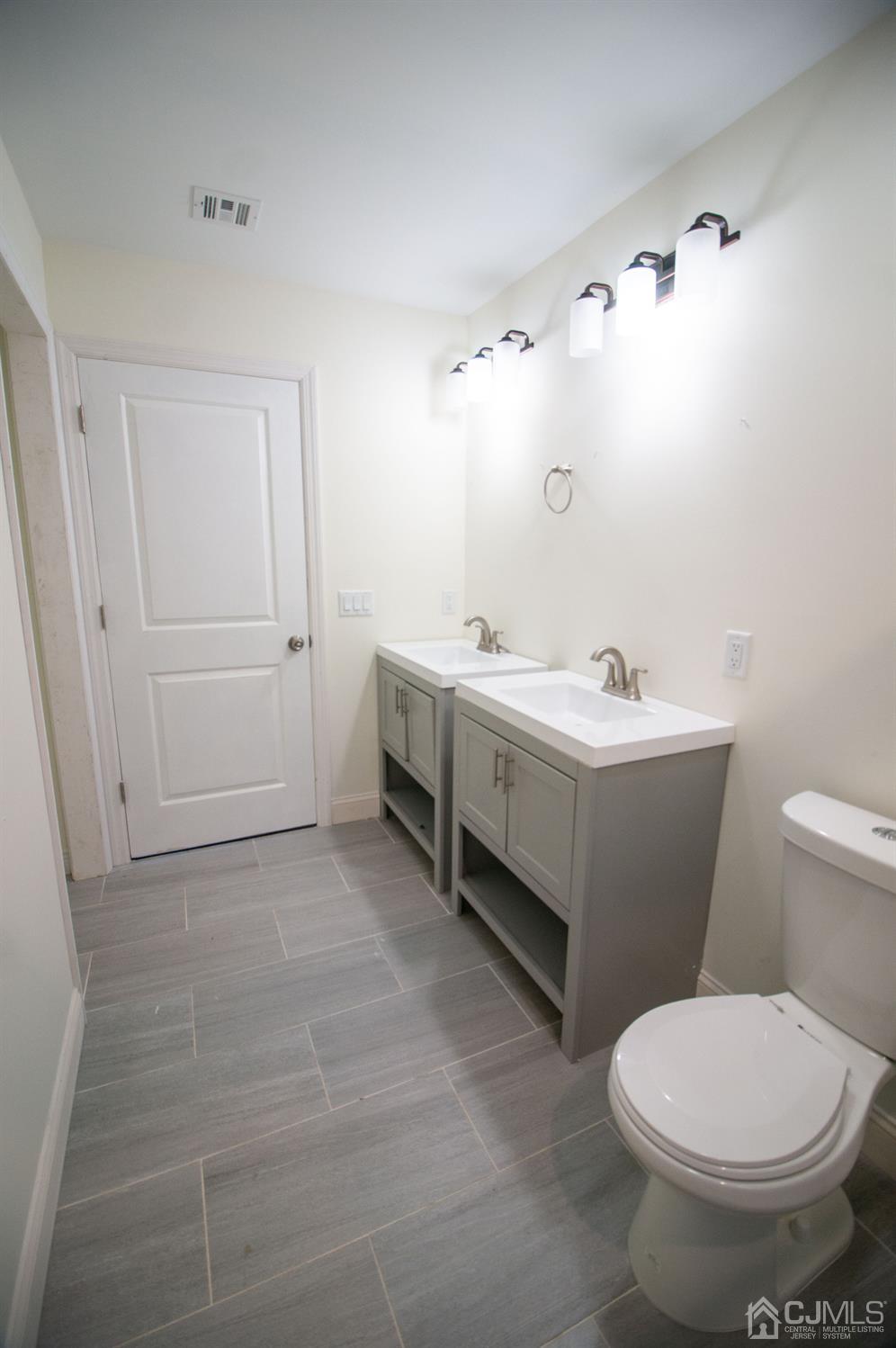 14 Caldwell Road Edison, NJ 08817 - Photo 14 of 22 a bathroom with a sink a toilet and mirror