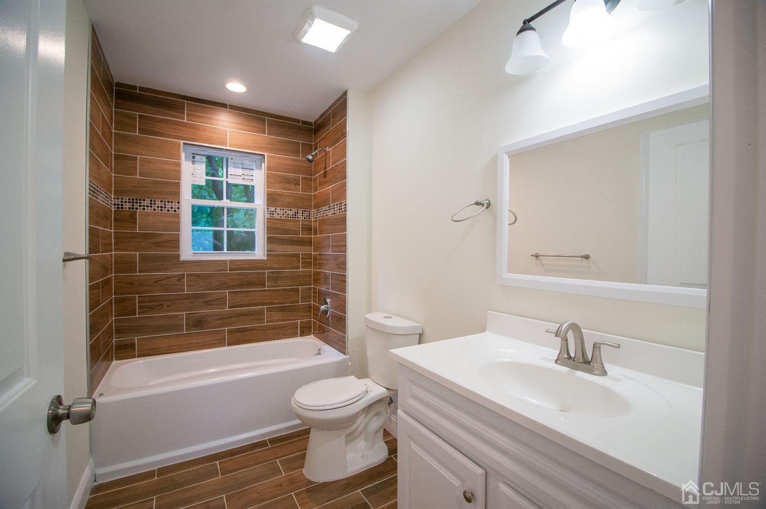 14 Caldwell Road Edison, NJ 08817 - Photo 15 of 22 a bathroom with a sink a toilet and shower