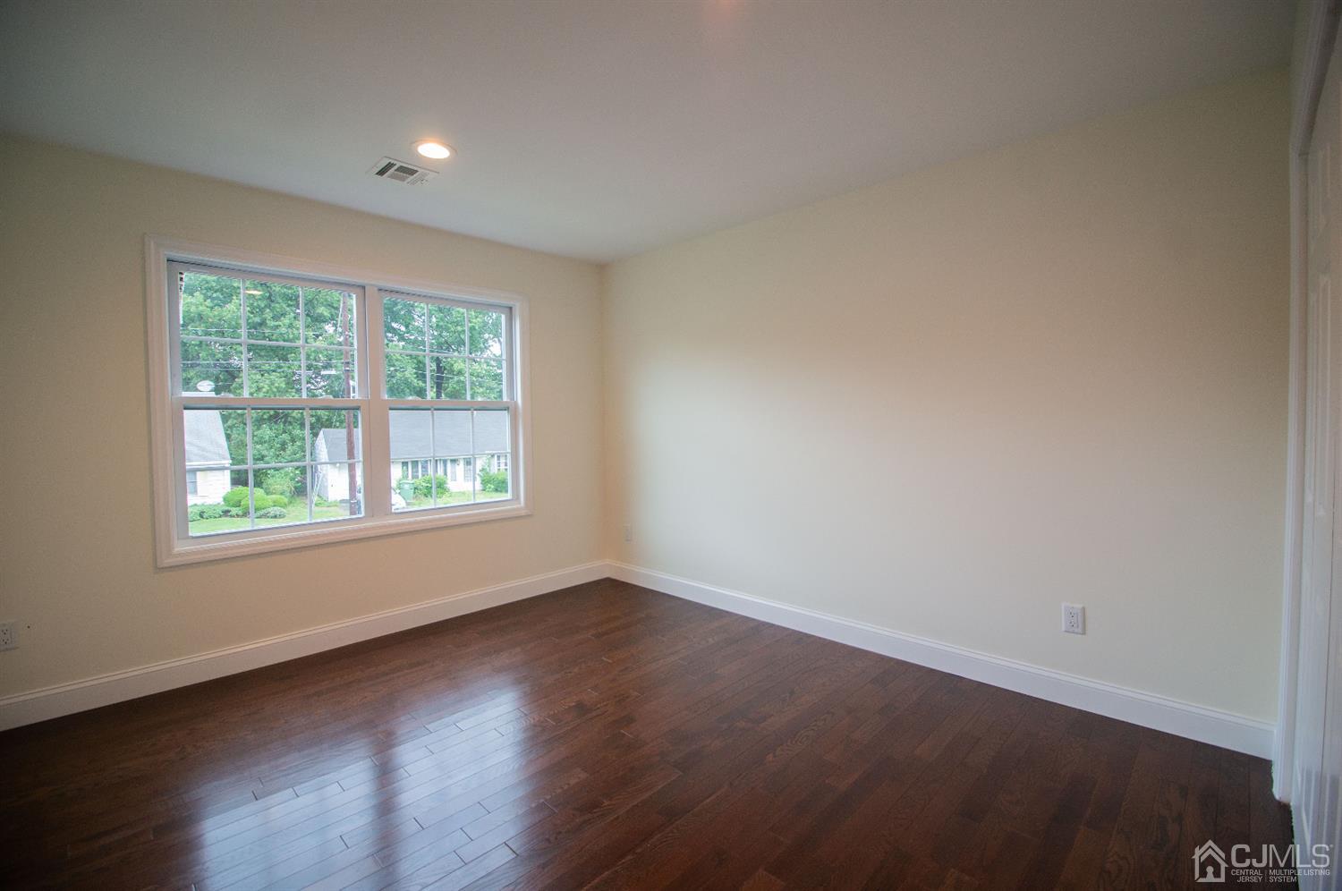 14 Caldwell Road Edison, NJ 08817 - Photo 16 of 22 an empty room with wooden floor and windows