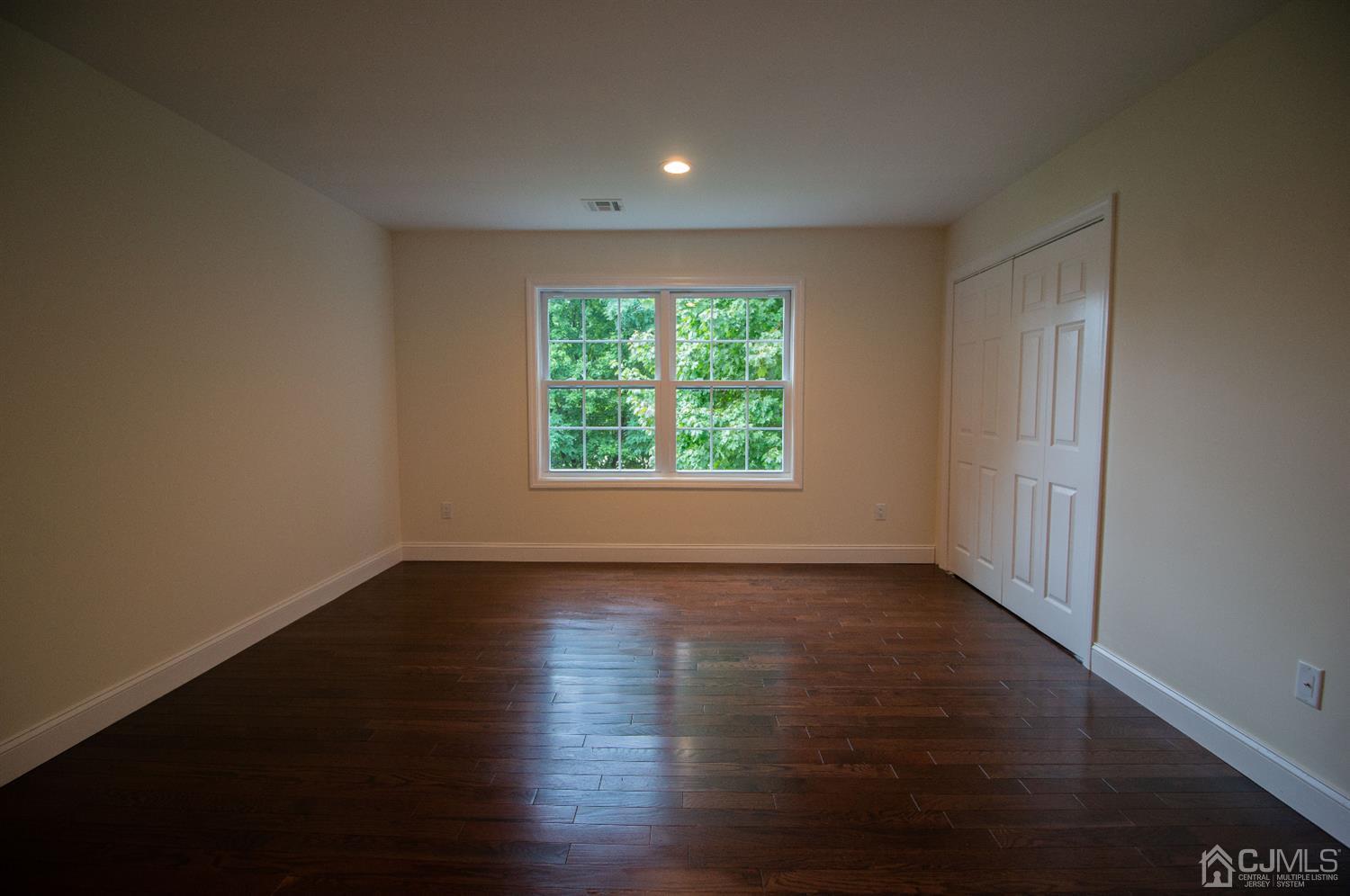 14 Caldwell Road Edison, NJ 08817 - Photo 18 of 22 a view of an empty room with wooden floor and a window