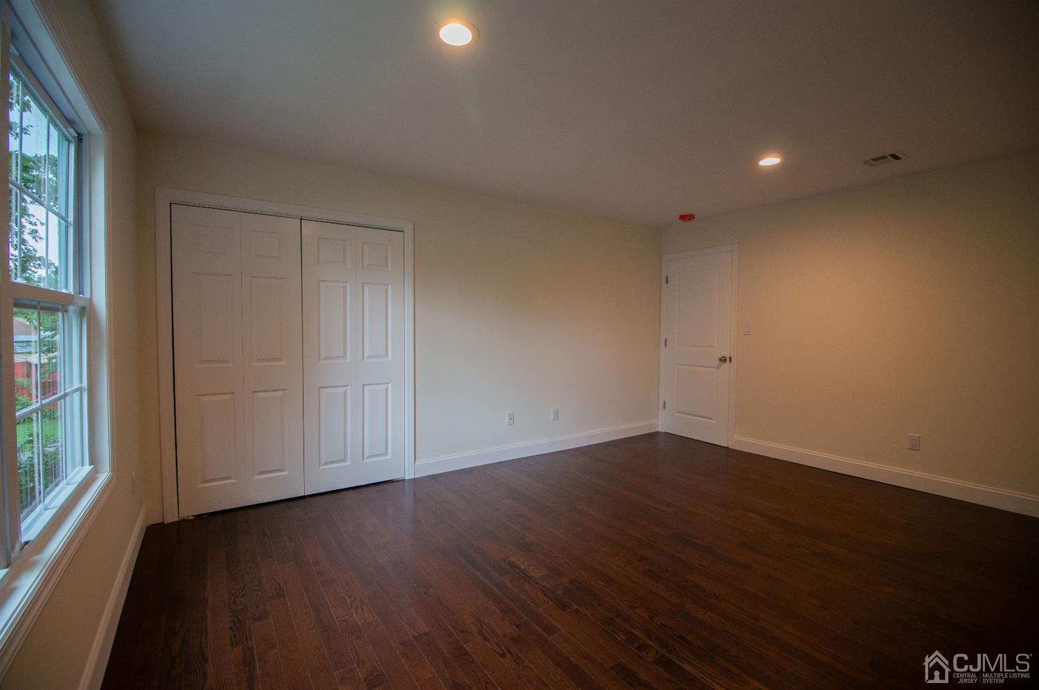 14 Caldwell Road Edison, NJ 08817 - Photo 19 of 22 a view of an empty room with wooden floor and a window