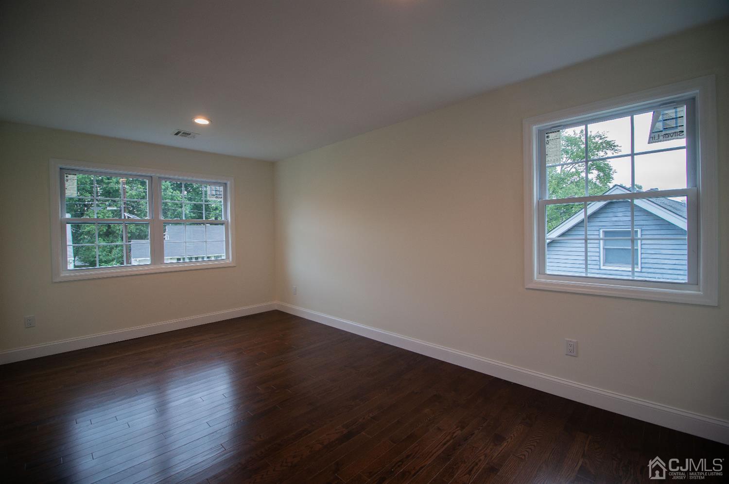 14 Caldwell Road Edison, NJ 08817 - Photo 20 of 22 a view of an empty room with wooden floor and a window