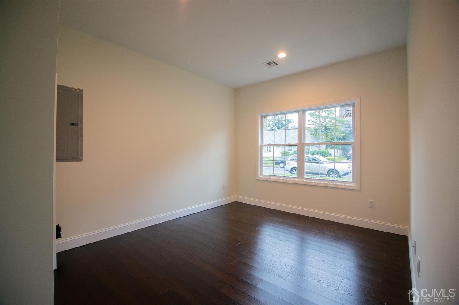 14 Caldwell Road Edison, NJ 08817 - Photo 6 of 22 an empty room with wooden floor and windows