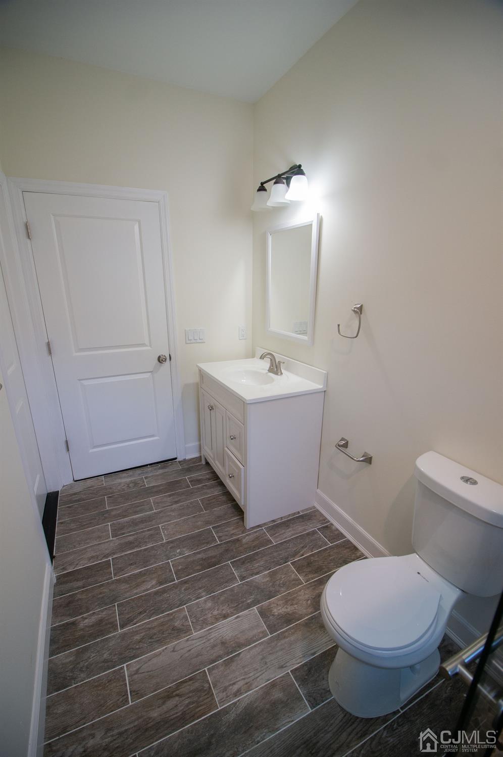 14 Caldwell Road Edison, NJ 08817 - Photo 9 of 22 a bathroom with a sink toilet and mirror