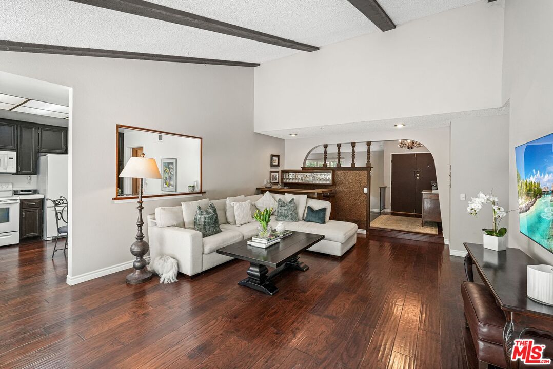 10621 Vanalden Avenue Porter Ranch, CA 91326 - Photo 16 of 38 a living room with furniture and a wooden floor