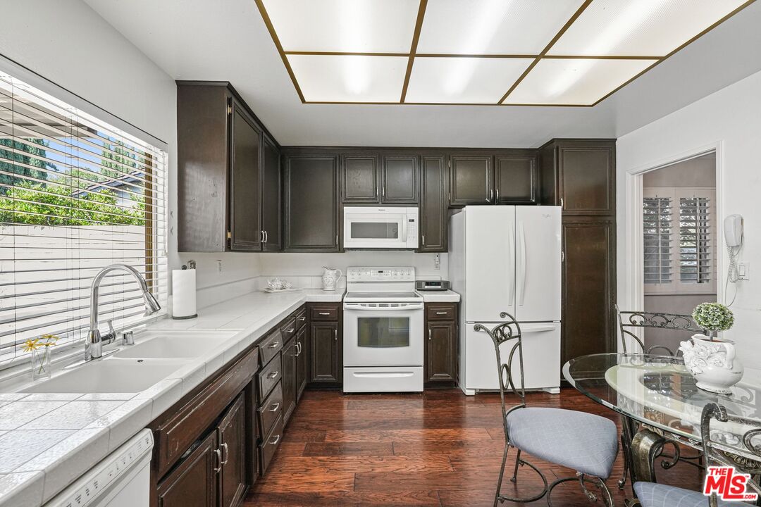10621 Vanalden Avenue Porter Ranch, CA 91326 - Photo 18 of 38 a kitchen with a sink cabinets and wooden floor