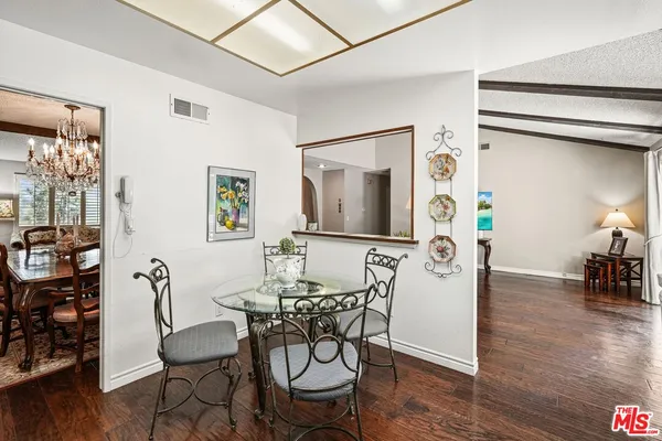 a view of a dining room with furniture and wooden floor