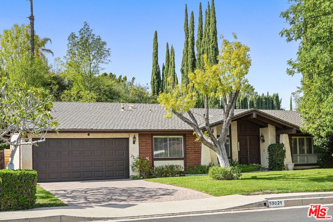 10621 Vanalden Avenue Porter Ranch, CA 91326 - Photo 2 of 38 a front view of a house with a yard and trees