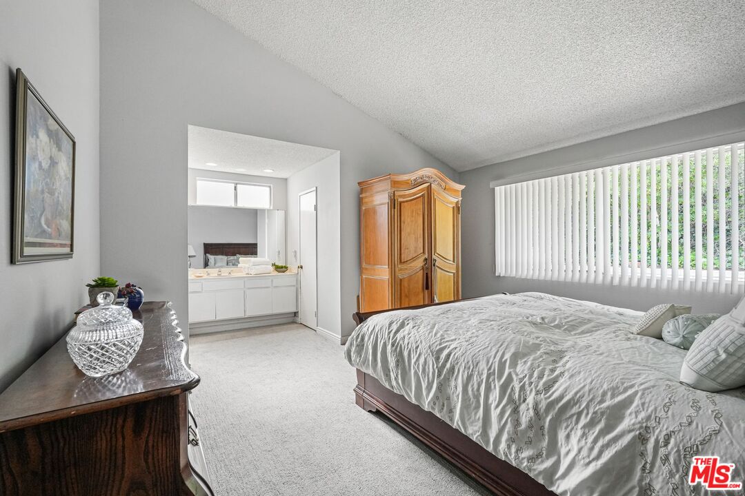 10621 Vanalden Avenue Porter Ranch, CA 91326 - Photo 25 of 38 a bedroom with a bed and dresser
