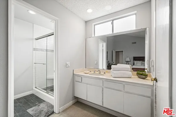 a en suite bathroom with a double vanity sink and a mirror