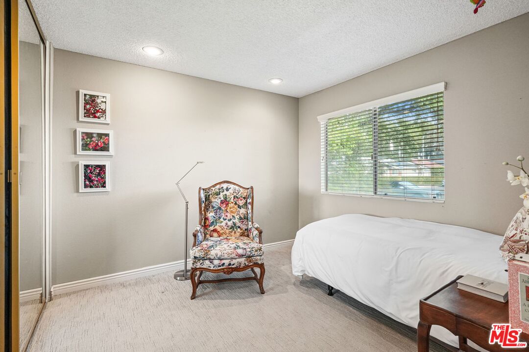10621 Vanalden Avenue Porter Ranch, CA 91326 - Photo 28 of 38 a bedroom with a bed and a window