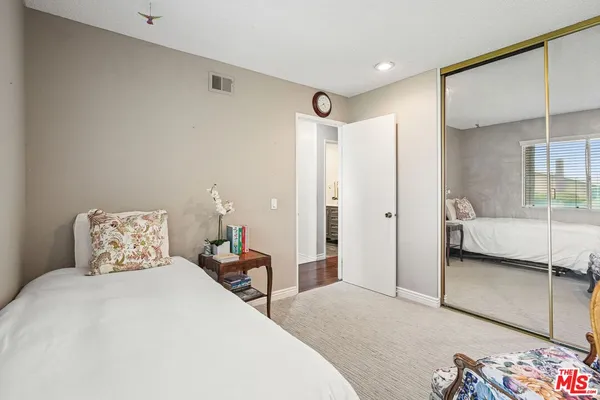 a bedroom with a bed and a mirror