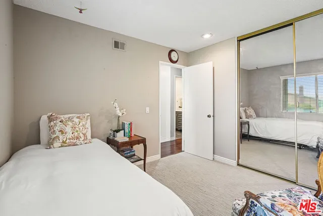 a bedroom with a bed and a mirror