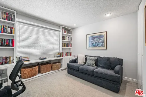 a living room with furniture a rug and a window