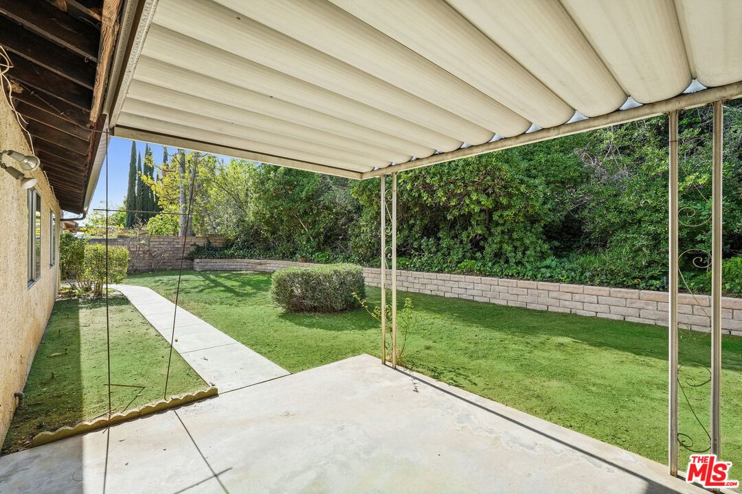 10621 Vanalden Avenue Porter Ranch, CA 91326 - Photo 37 of 38 a view of a backyard with a garden