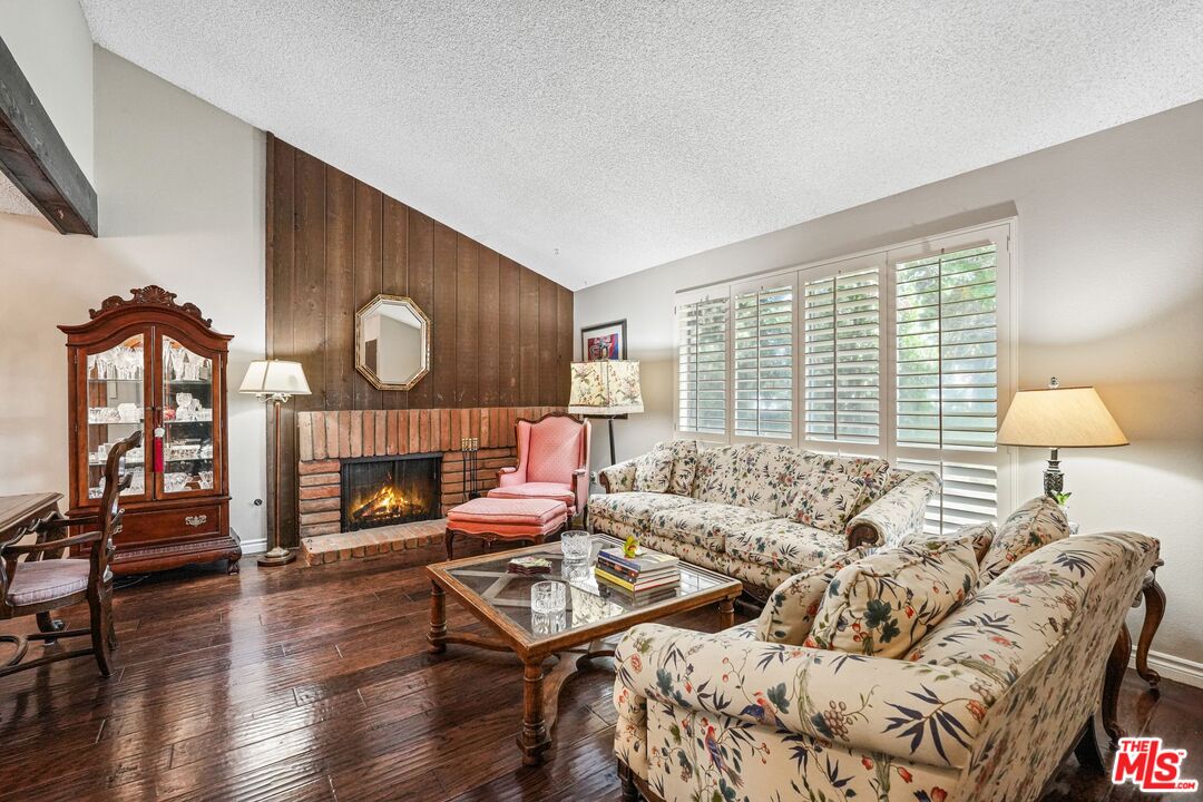 10621 Vanalden Avenue Porter Ranch, CA 91326 - Photo 6 of 38 a living room with furniture and a wooden floor