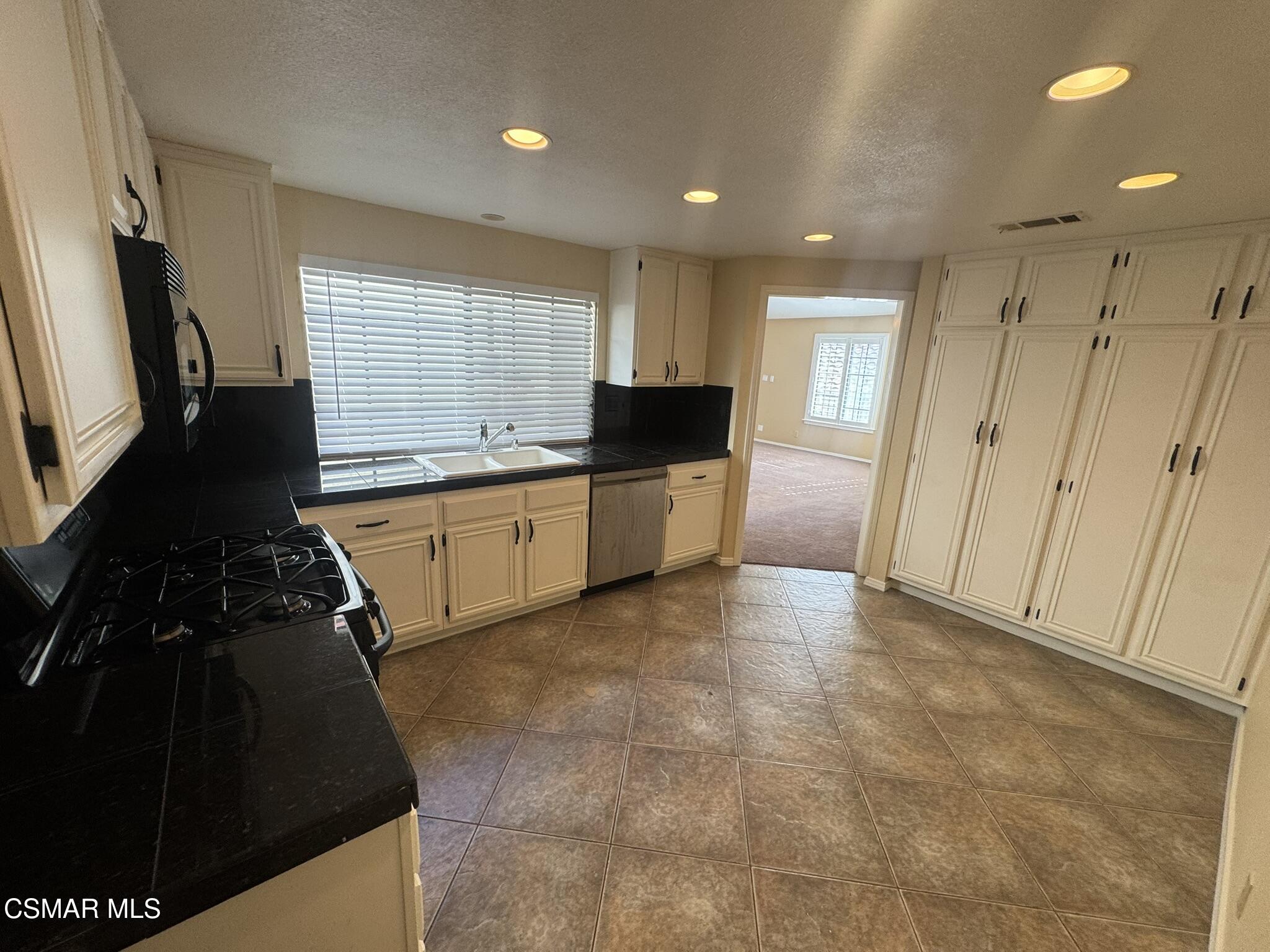 616 Cartpath Place Simi Valley, CA 93065 - Photo 11 of 17 a large kitchen with a stove and a refrigerator