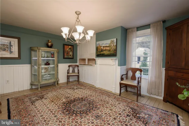 a view of a dining room with furniture and chandelier