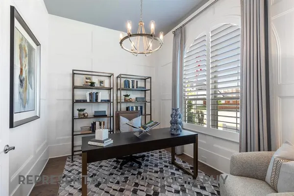 a view of a dining room with furniture a chandelier and wooden floor