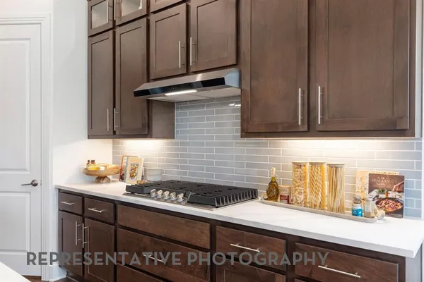 a kitchen with a sink cabinets and appliances