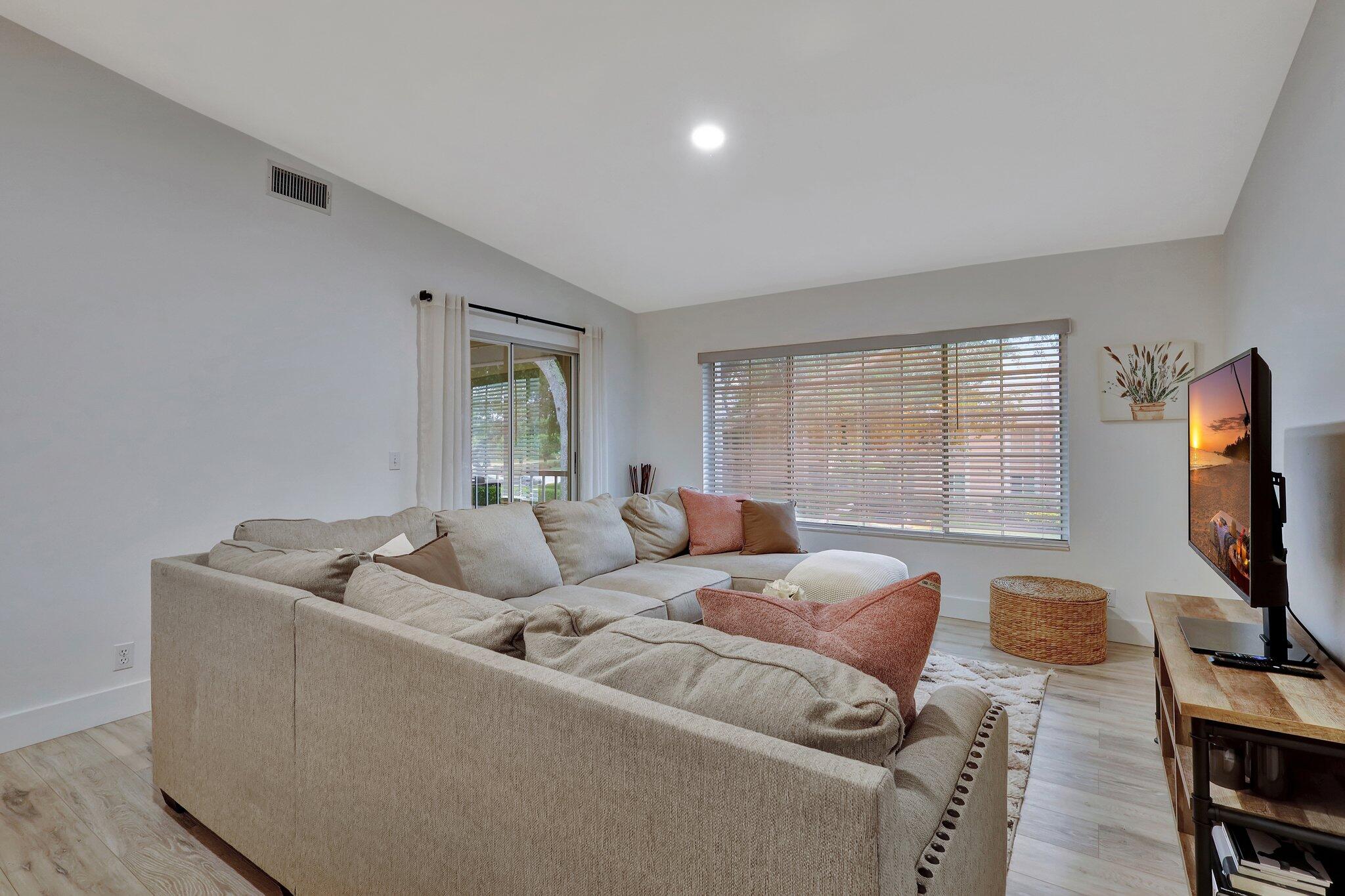 13851 Oneida Drive, Unit B2 Delray Beach, FL 33446 - Photo 11 of 30 a living room with furniture and a flat screen tv