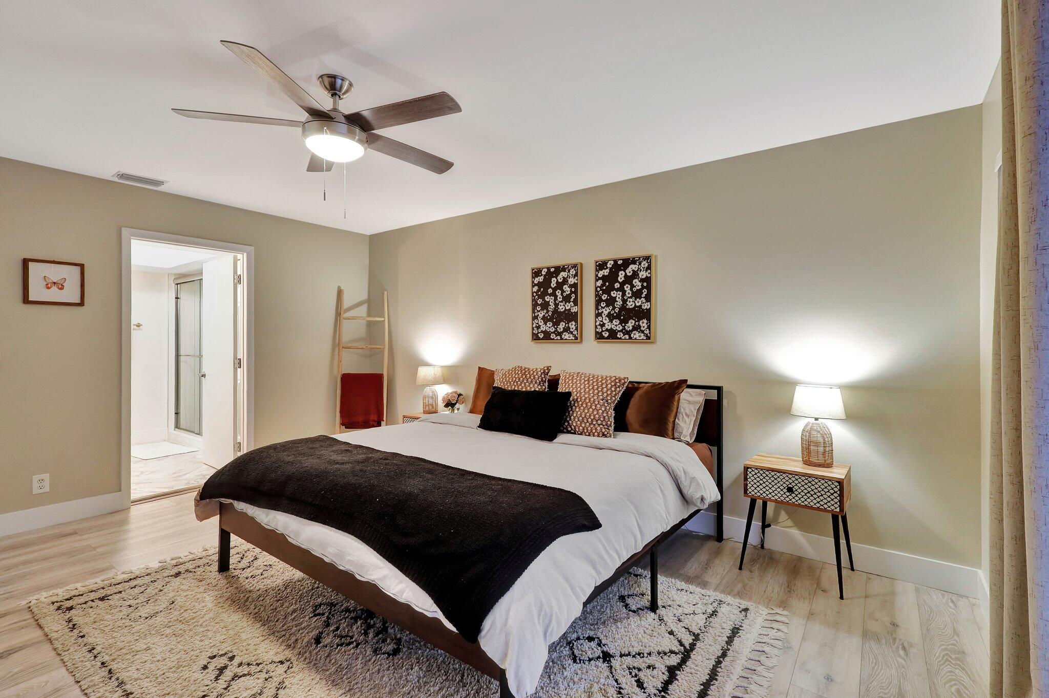 13851 Oneida Drive, Unit B2 Delray Beach, FL 33446 - Photo 13 of 30 a bedroom with a bed and a chandelier