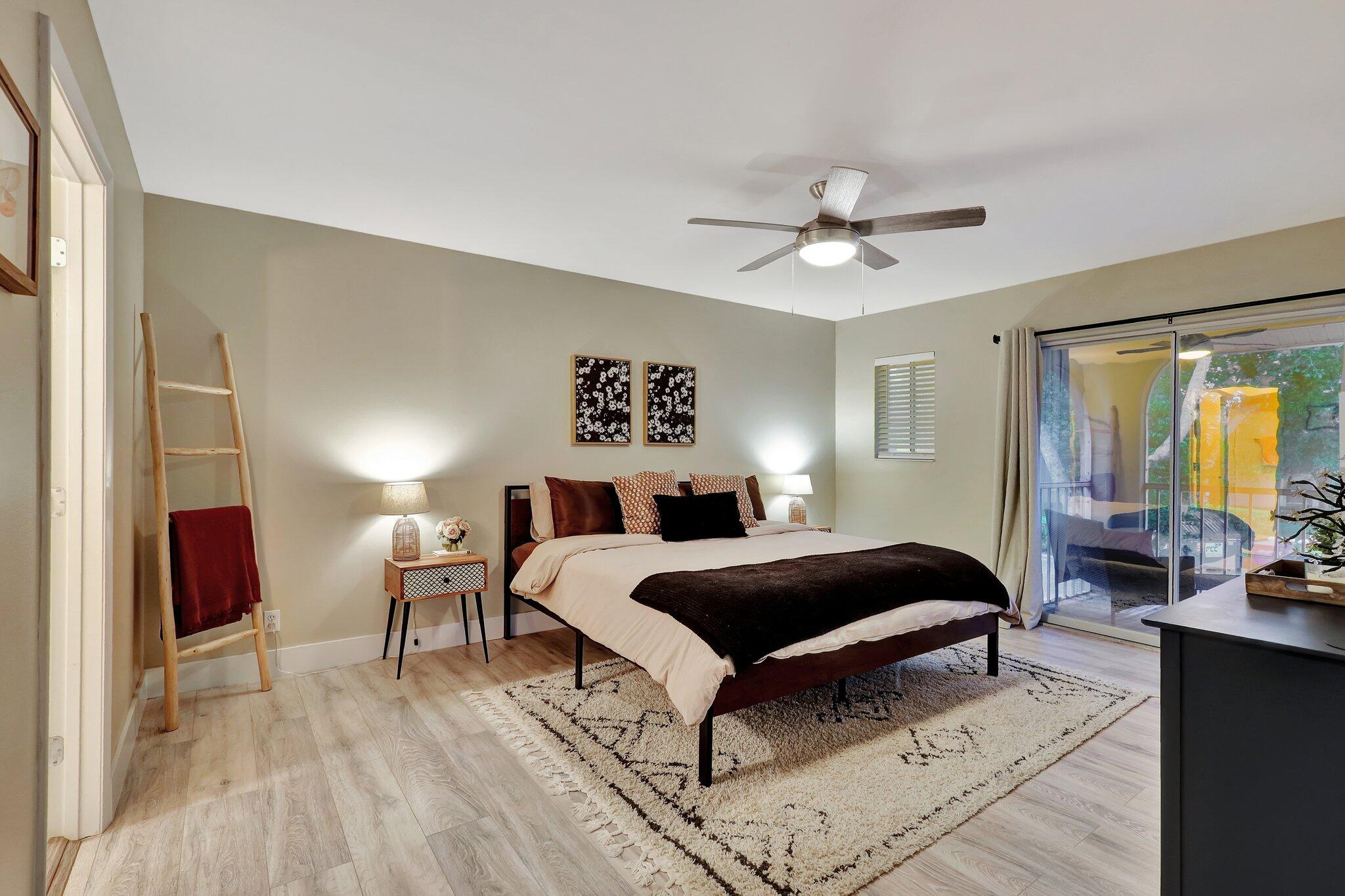 13851 Oneida Drive, Unit B2 Delray Beach, FL 33446 - Photo 14 of 30 a bedroom with a bed and a chandelier