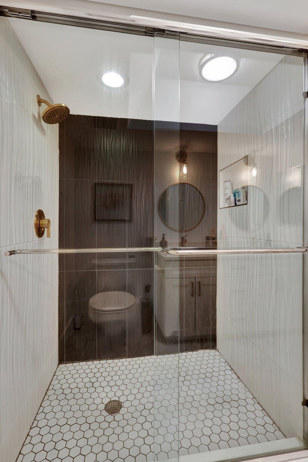 13851 Oneida Drive, Unit B2 Delray Beach, FL 33446 - Photo 19 of 30 a bathroom with a sink a toilet and a mirror