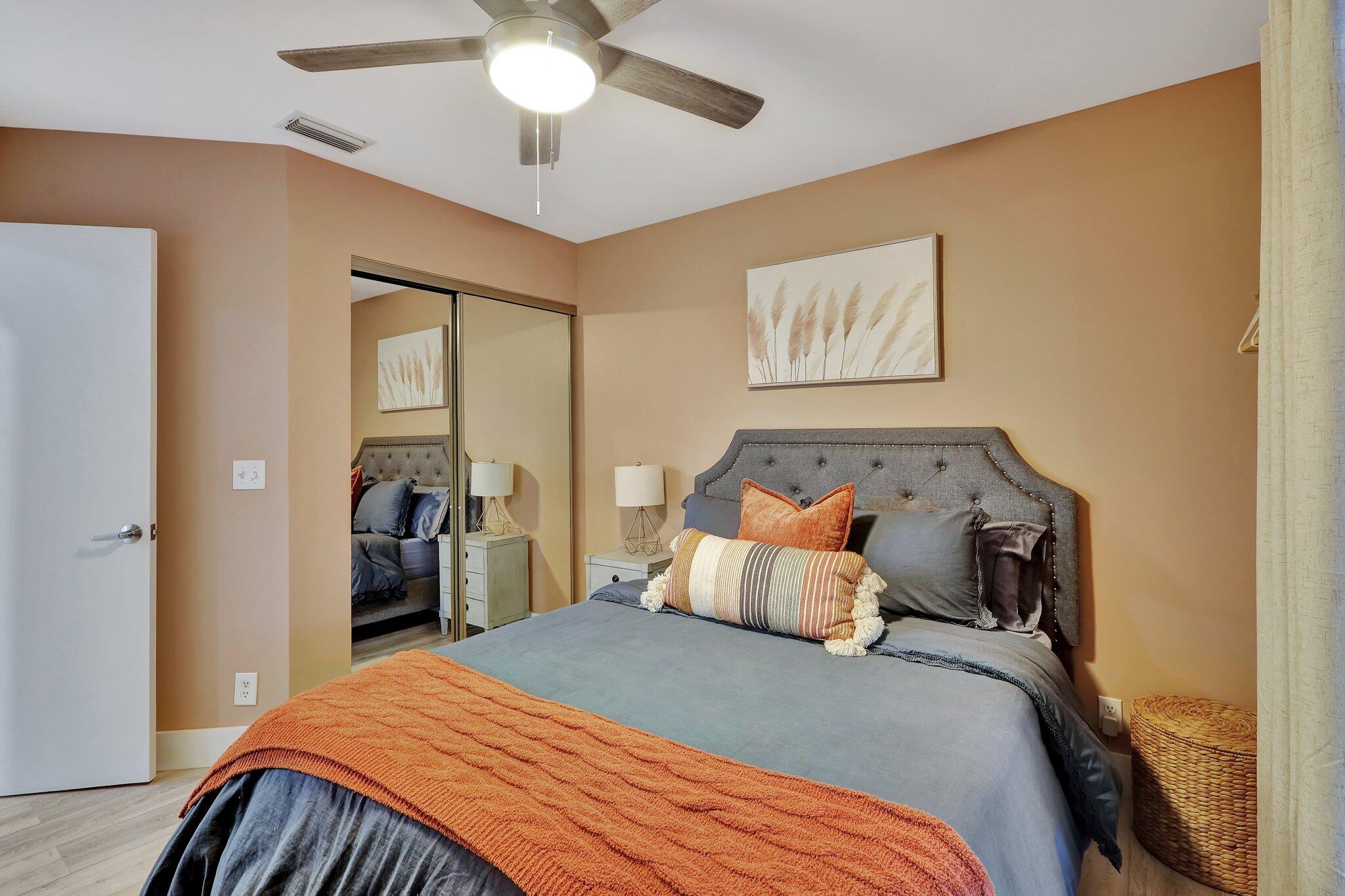 13851 Oneida Drive, Unit B2 Delray Beach, FL 33446 - Photo 21 of 30 a bedroom with bed and wooden floor