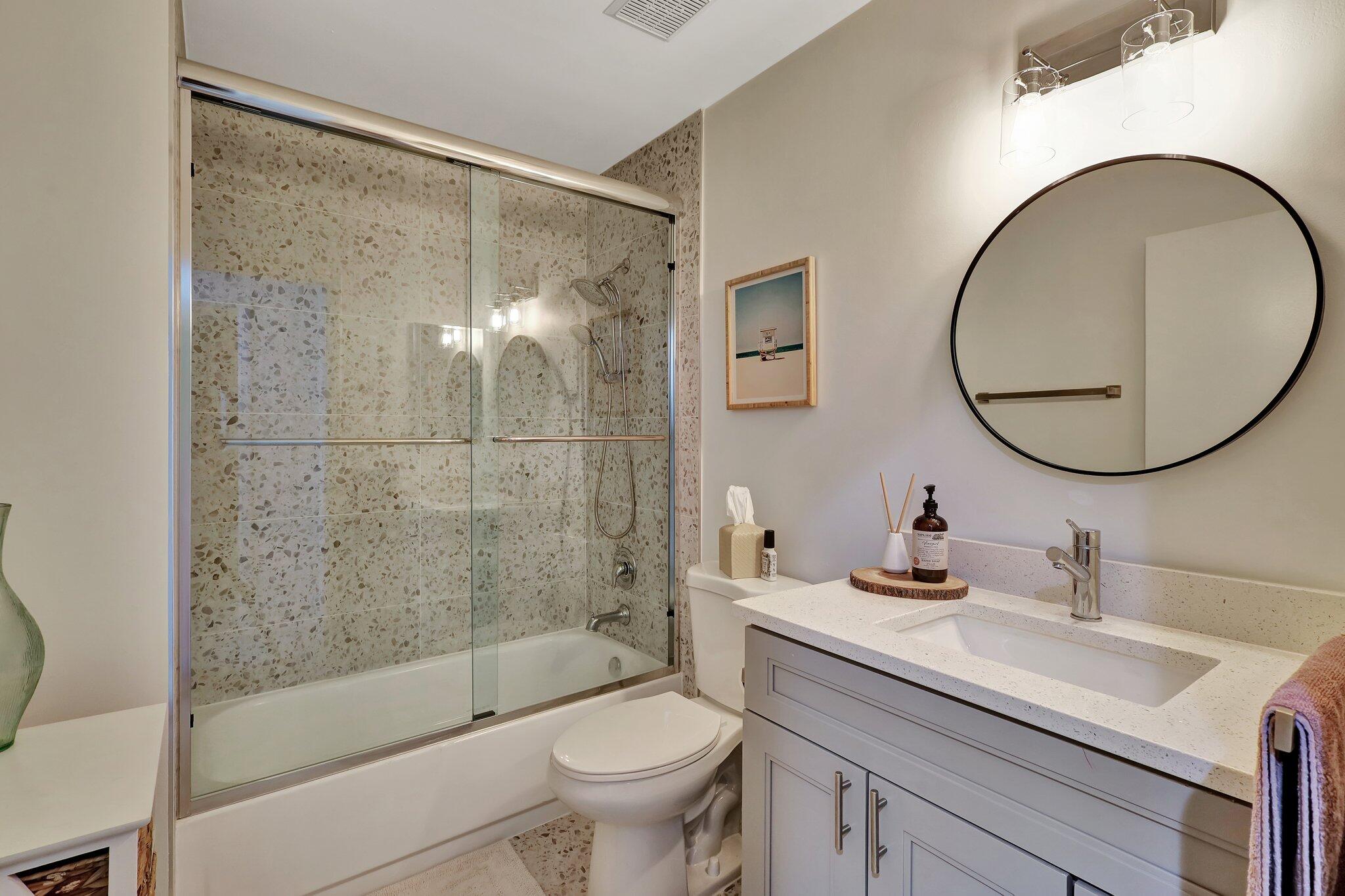 13851 Oneida Drive, Unit B2 Delray Beach, FL 33446 - Photo 22 of 30 a bathroom with a sink a toilet and a mirror