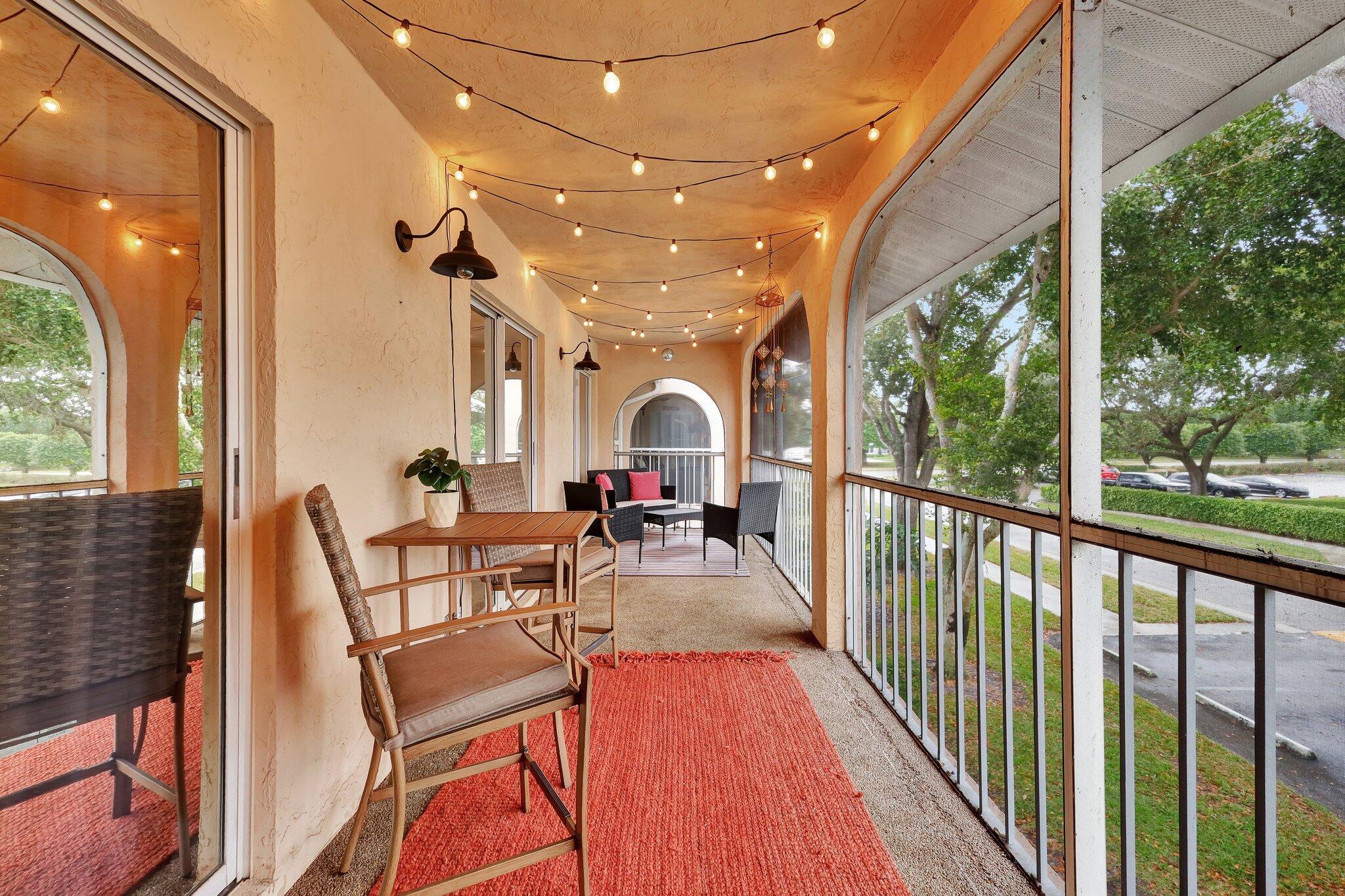 13851 Oneida Drive, Unit B2 Delray Beach, FL 33446 - Photo 27 of 30 a view of a patio with dining table and chairs
