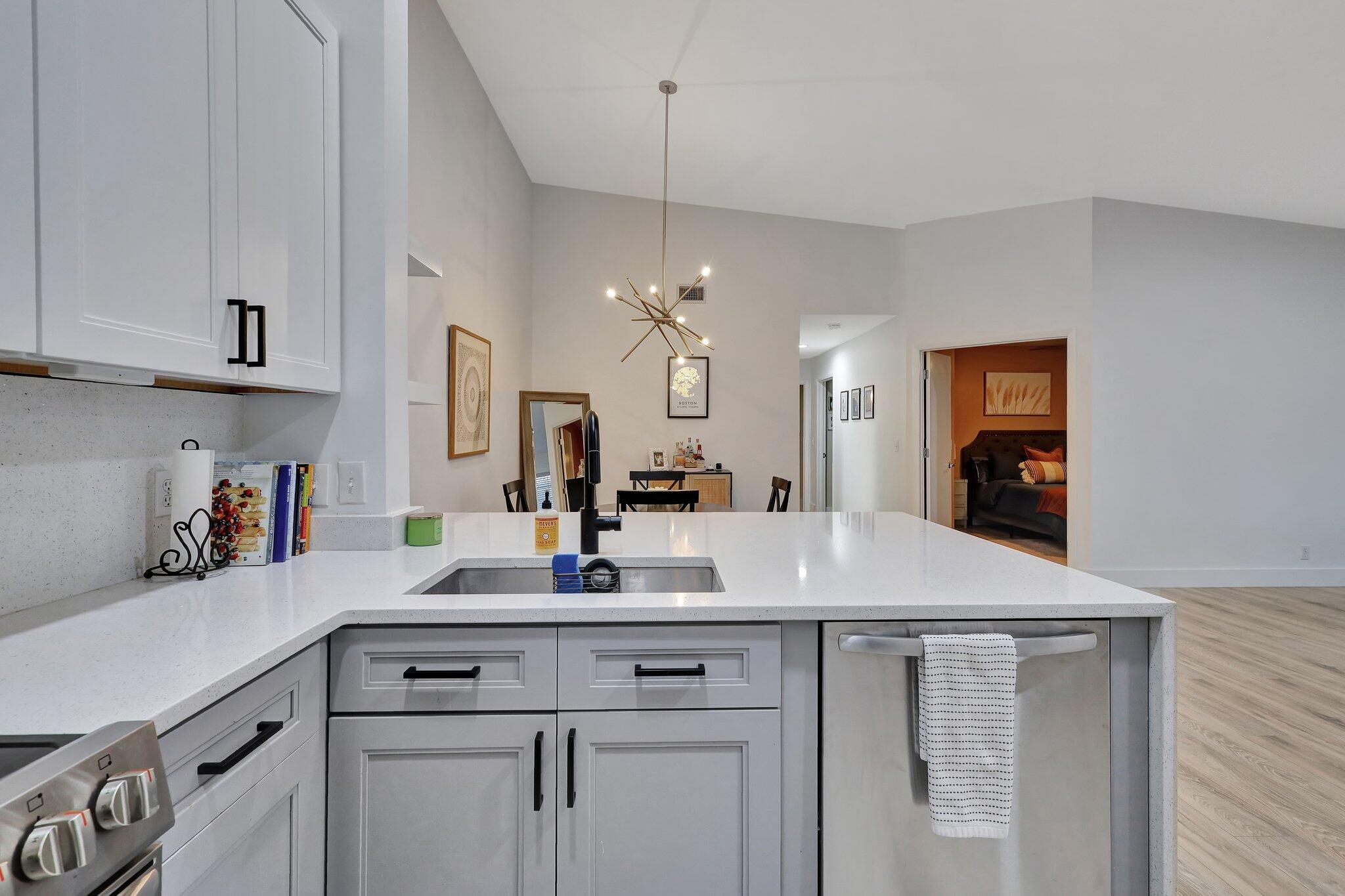 13851 Oneida Drive, Unit B2 Delray Beach, FL 33446 - Photo 6 of 30 a kitchen with a sink cabinets and wooden floor