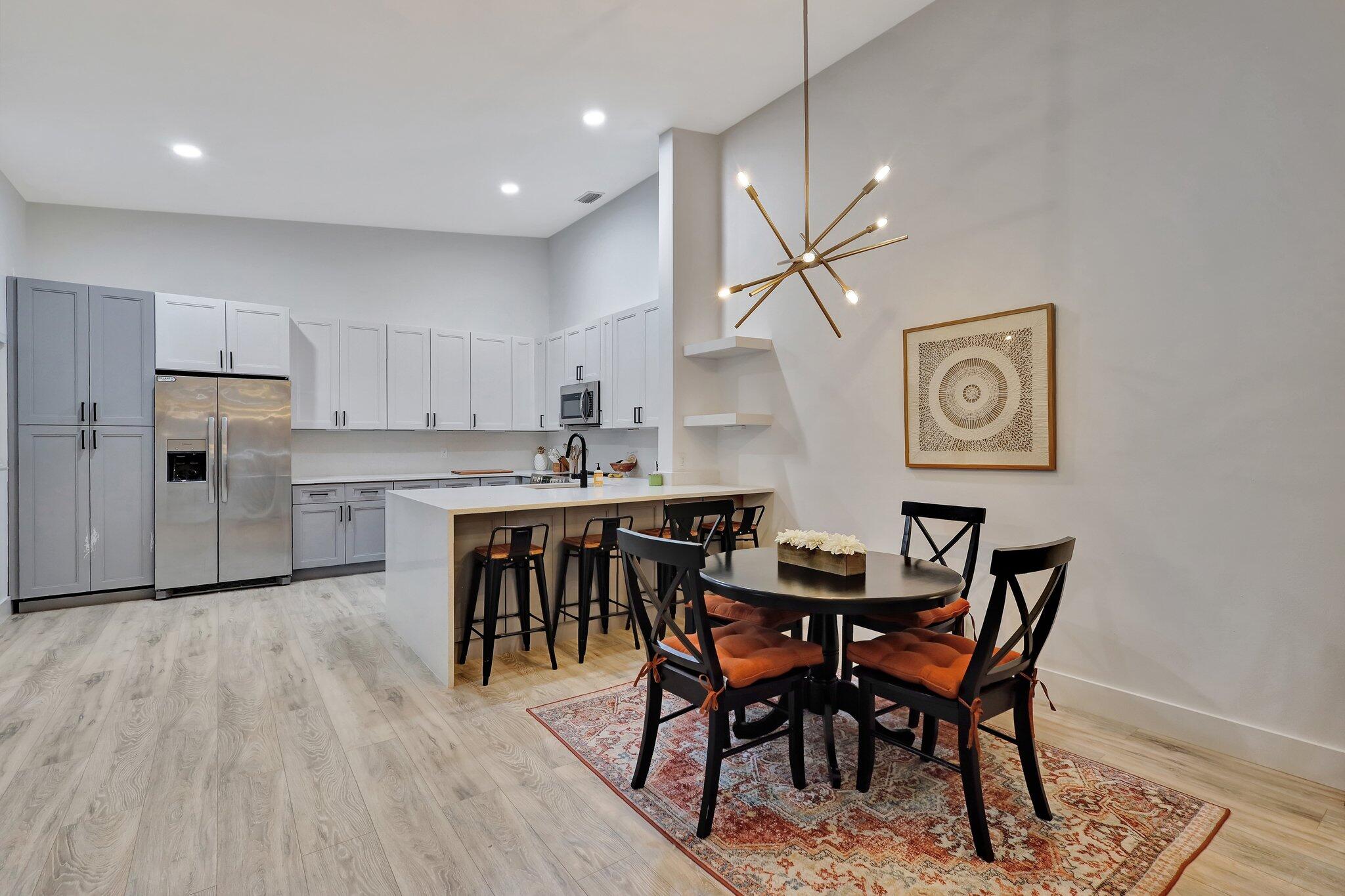 13851 Oneida Drive, Unit B2 Delray Beach, FL 33446 - Photo 9 of 30 a view of kitchen with cabinets and wooden floor