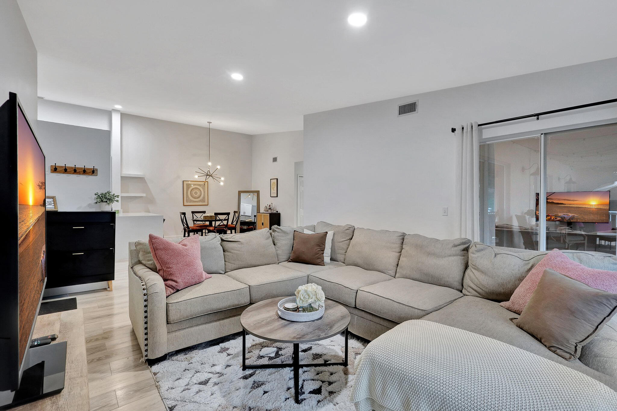 13851 Oneida Drive, Unit B2 Delray Beach, FL 33446 - Photo 10 of 30 a living room with furniture a mirror and a couch
