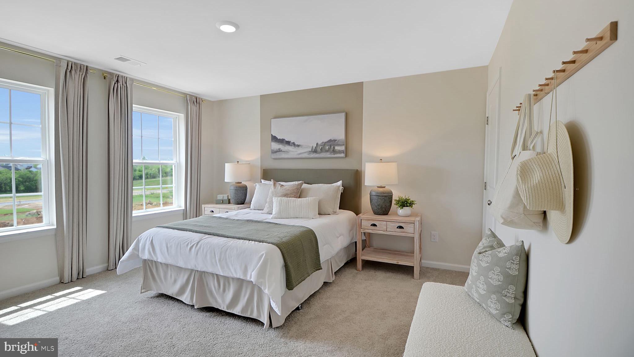 115 Winding Road Easton, PA 18040 - Photo 17 of 26 a spacious bedroom with a bed and a painting on the wall