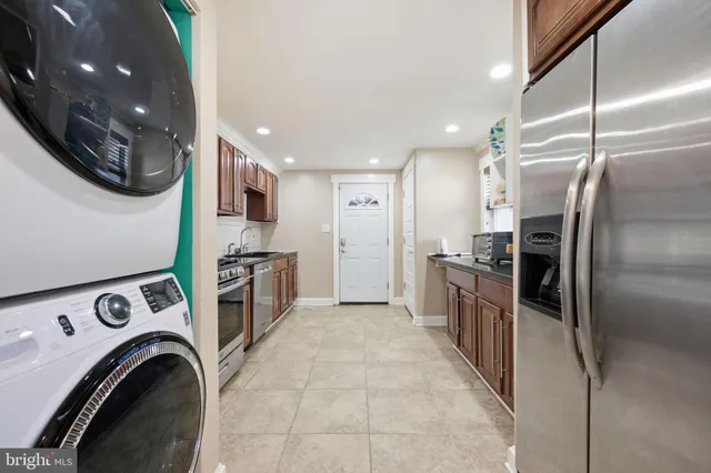 a kitchen with stainless steel appliances granite countertop a refrigerator and a sink
