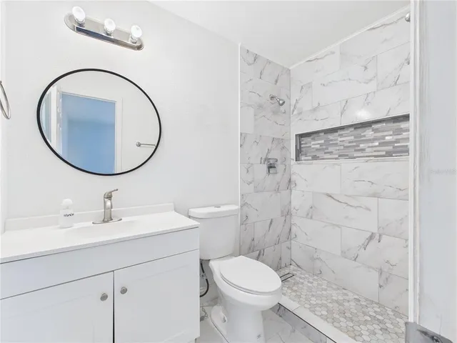 a bathroom with a sink toilet and shower
