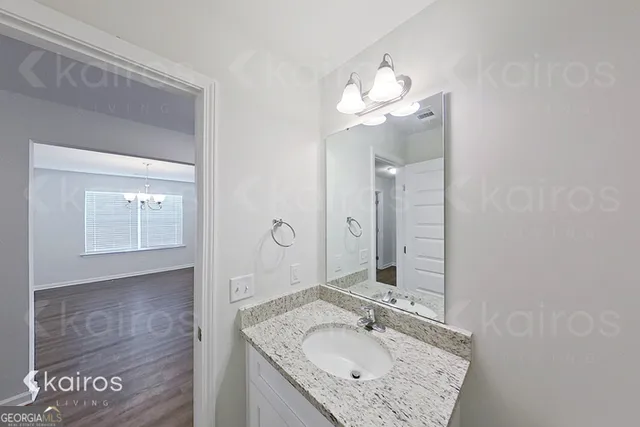 a bathroom with a sink vanity and mirror