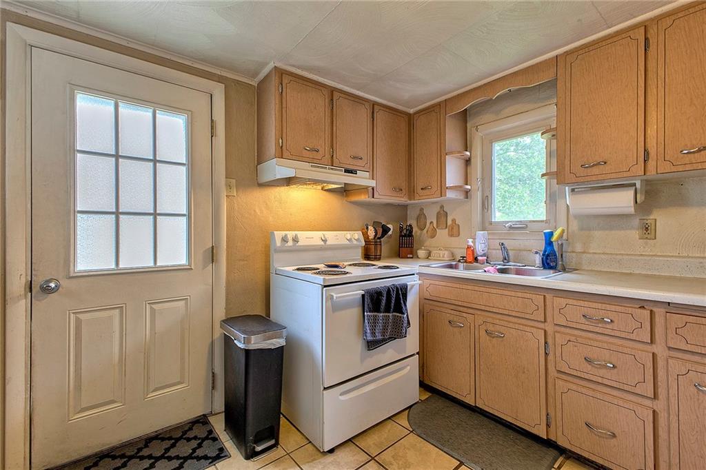 108 Pandora Road Loyalhanna, PA 15661 - Photo 17 of 23 a kitchen with white cabinets and white appliances