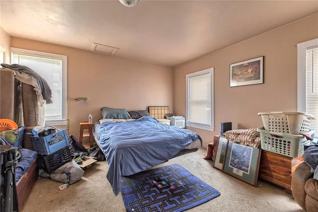 a bedroom with furniture and a window