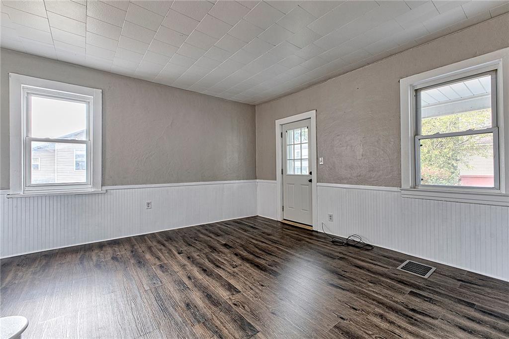 108 Pandora Road Loyalhanna, PA 15661 - Photo 4 of 23 an empty room with wooden floor and windows