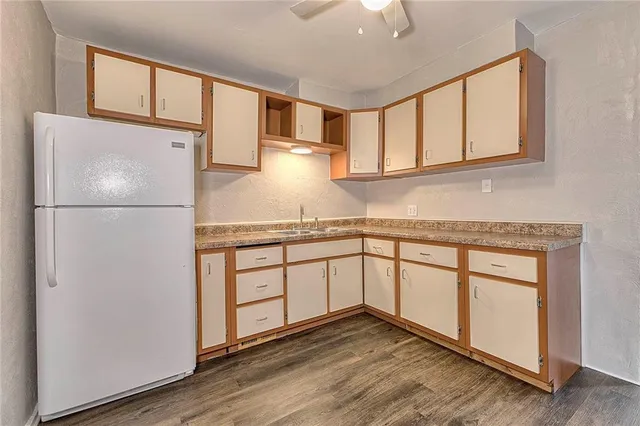 a kitchen with stainless steel appliances granite countertop a refrigerator sink and cabinets