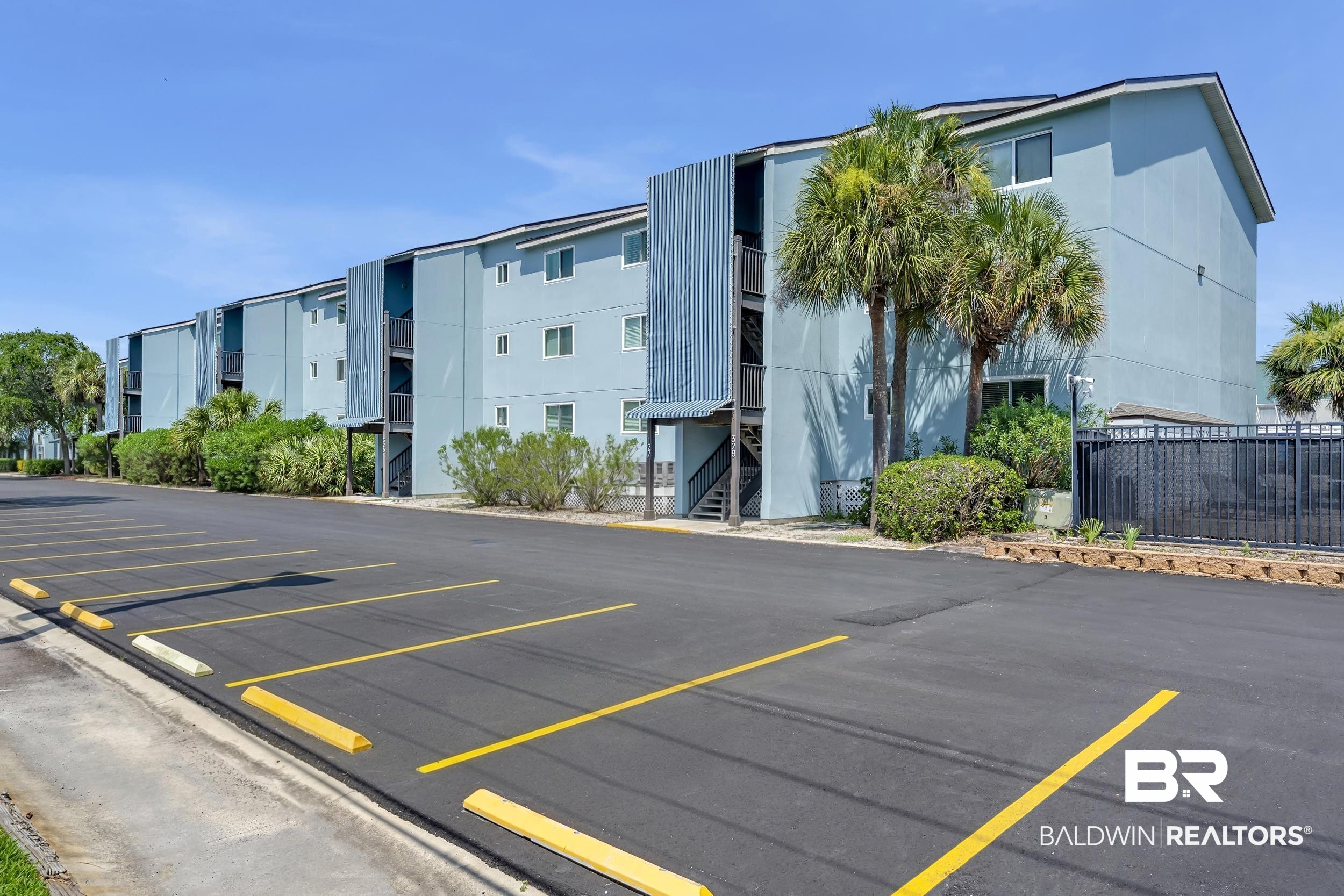 14100 River Road, Unit 211 Pensacola, FL 32507 - Photo 42 of 56 Multi-story building featuring light blue siding, individual balconies, and external staircases