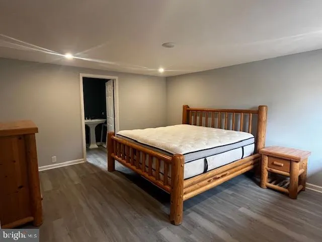 a bedroom with a bed and a tv on table