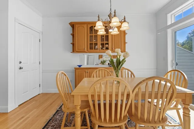 a view of a dining room with furniture and chandelier