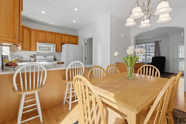a dining room with furniture a chandelier and window