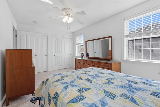 a bedroom with a large bed and a window