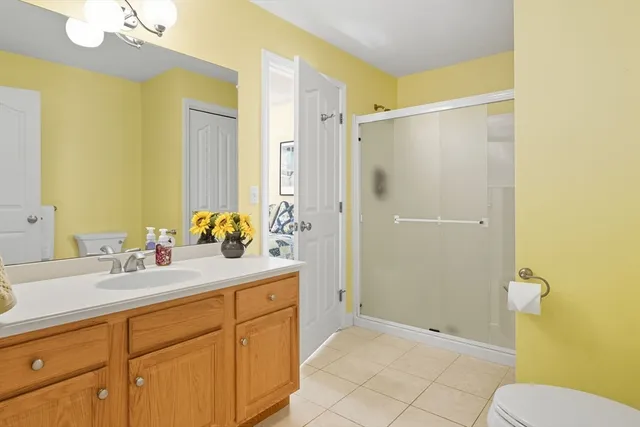 a bathroom with a granite countertop sink toilet and shower